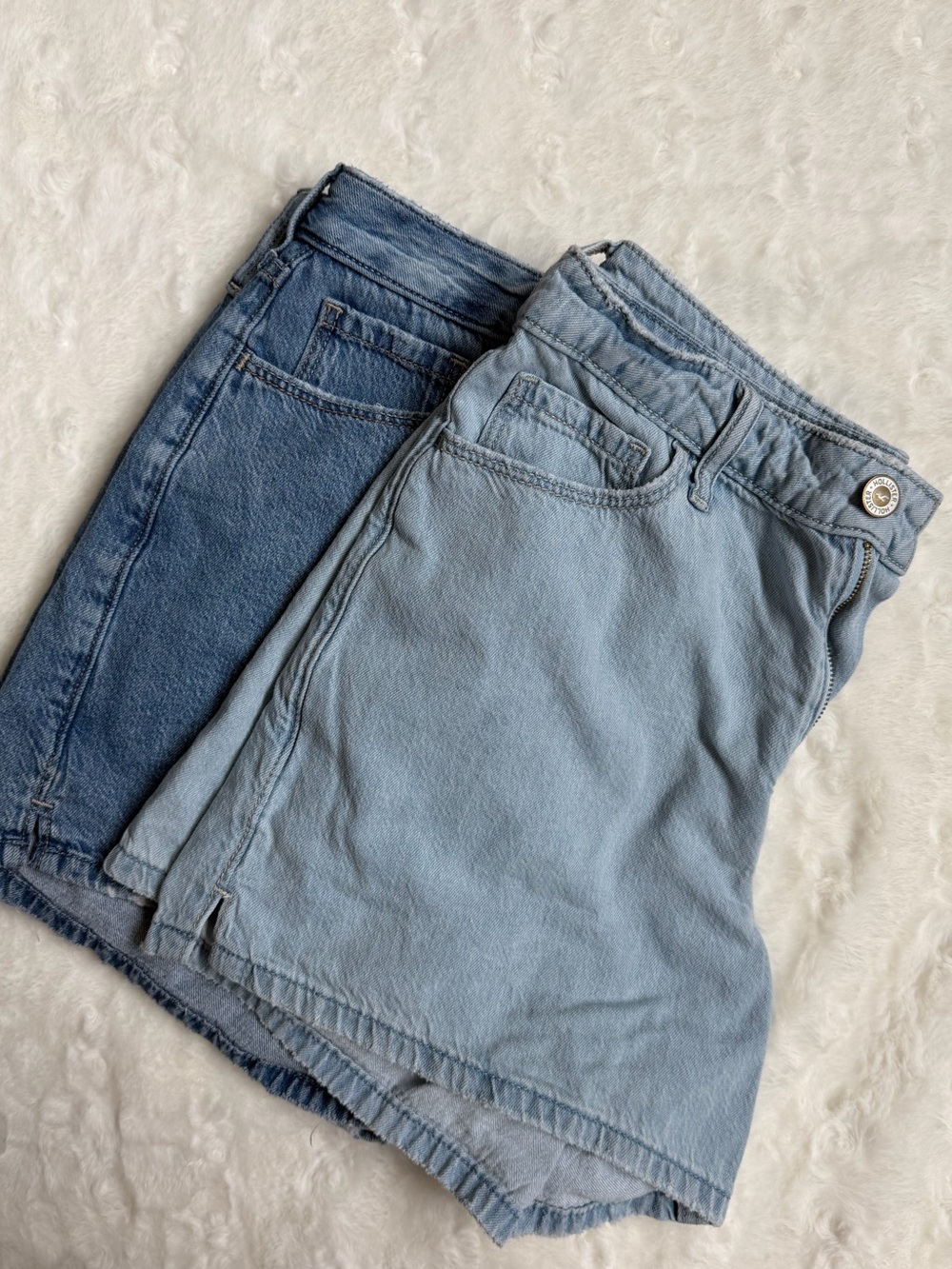 Two pairs of Hollister Women’s High-Rise Denim Shorts - Light Blue and Dark Blue